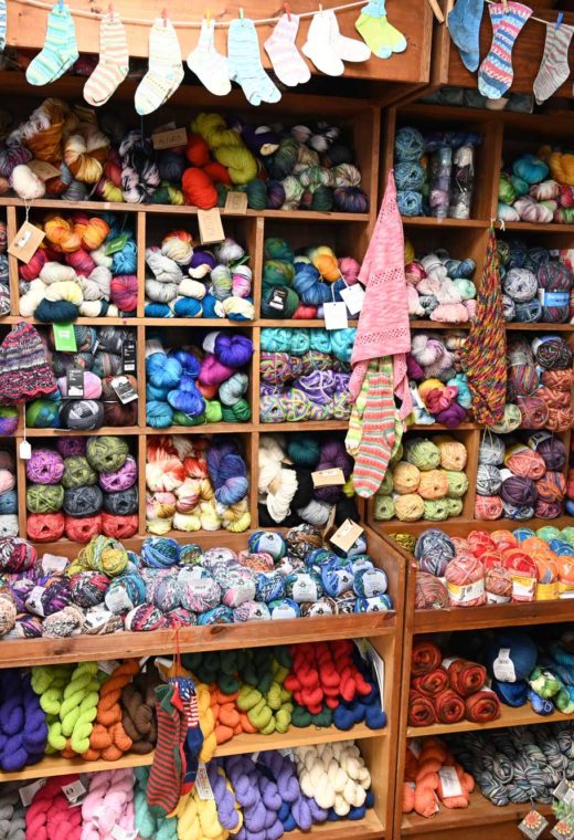 an image of yarn on the shelves of a knitting store in Connecticut